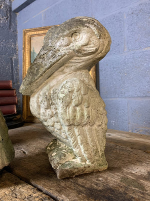 A trio of cast stone pelican statues