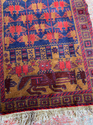 A Persian or Kurdish red ground pictorial rug - 165cm x 92cm