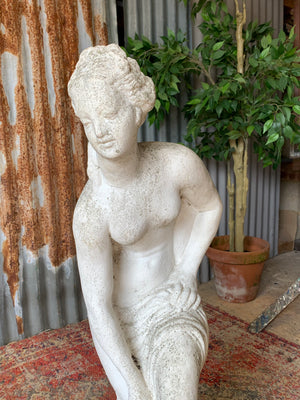 A pair of cast stone Pandora statues