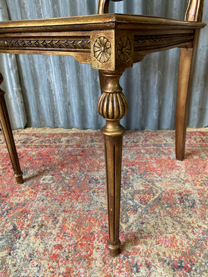 A rococo-style giltwood cane chair