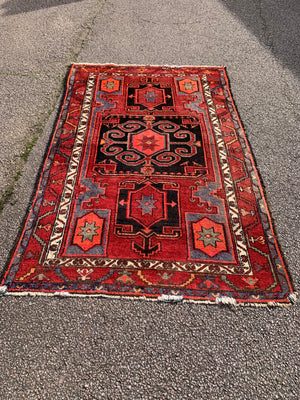 A Turkish red ground rug ~ 211cm x 138cm