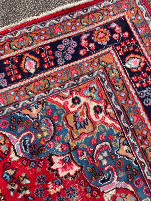 A large red ground Persian rug - 299cm x 194cm