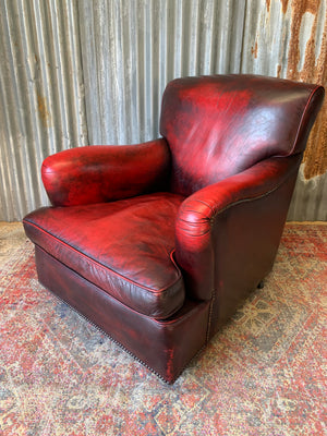 An oxblood red leather club chair