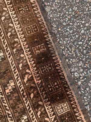 A Persian brown ground rectangular rug- 243cm x 166cm