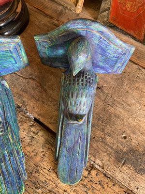 A pair of wooden corbels in the form of parrots