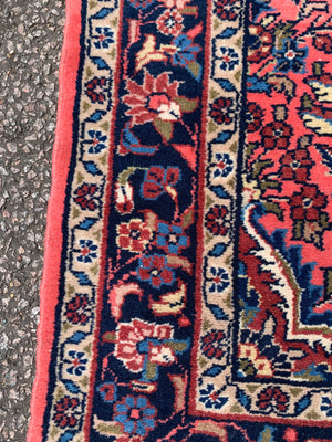 A Persian pink ground wool rug ~ 155cm x 105cm