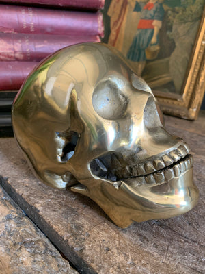 A life-size brass human skull model