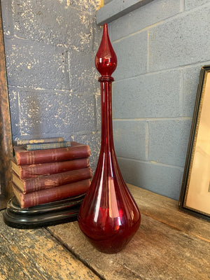 A large red glass carboy