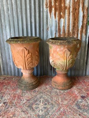 A pair of large terracotta acanthus urns