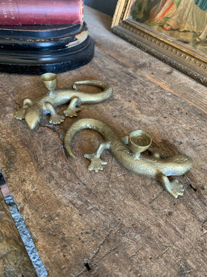 A pair of brass candlesticks in the form of lizards