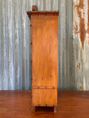 A small French faux bamboo mirrored cabinet