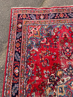 A large red ground Persian rug - 299cm x 194cm