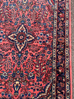 A Persian pink ground wool rug ~ 155cm x 105cm