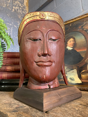 A carved wooden Buddha head