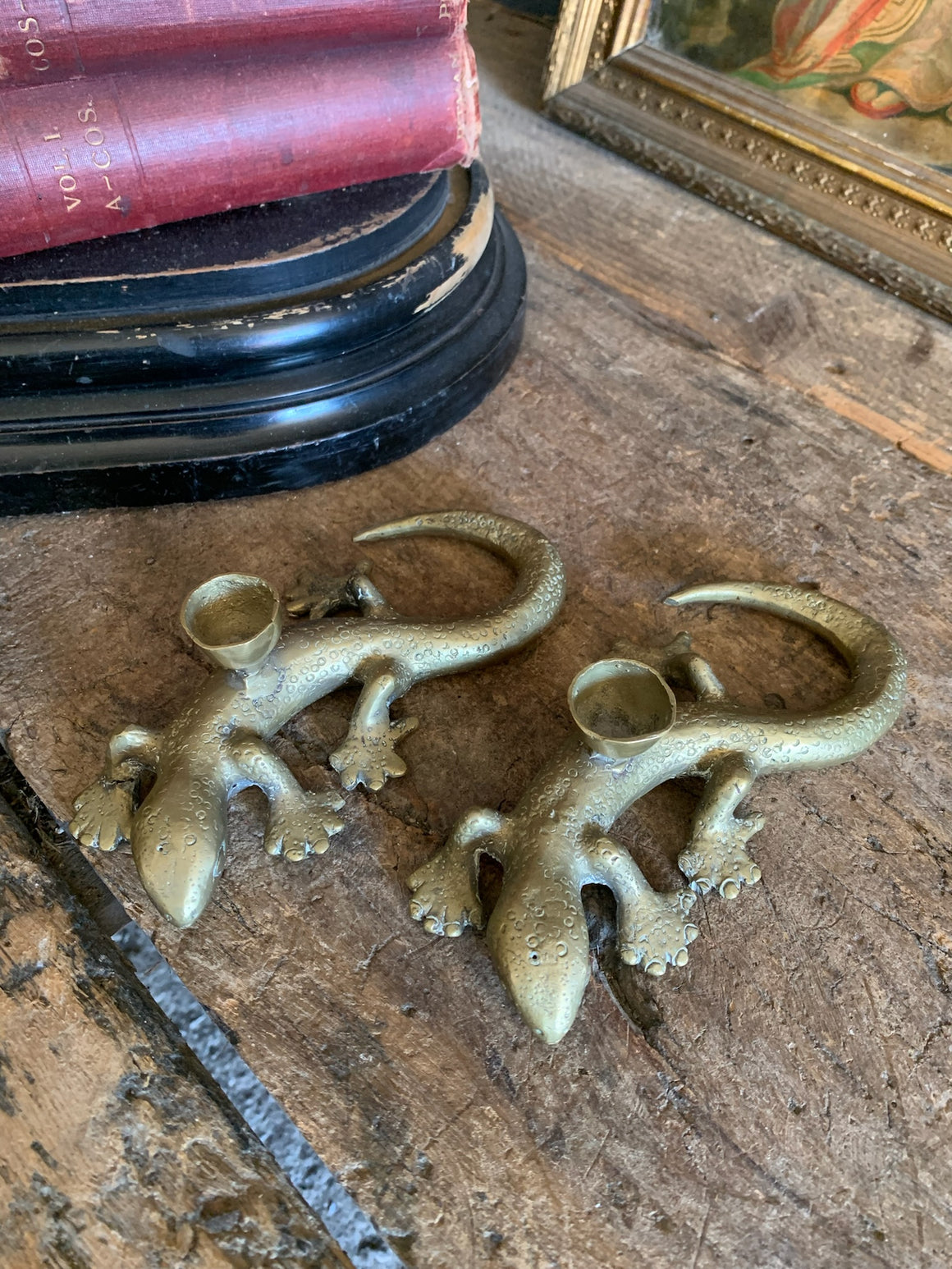 A pair of brass candlesticks in the form of lizards