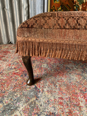 A large Persian carpet footstool