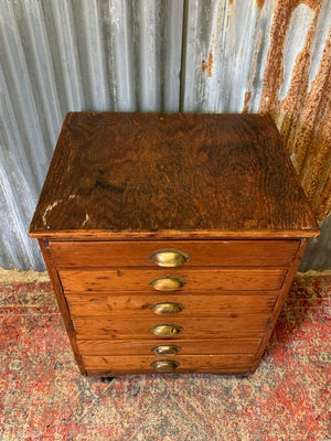 A pine chest of six drawers on castors