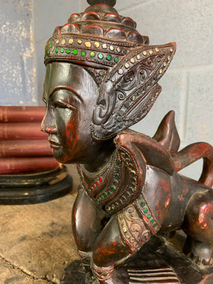 A carved wooden Manussiha sphinx statue