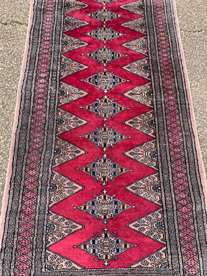 A long pink ground Persian runner rug ~ 318cm x 83cm