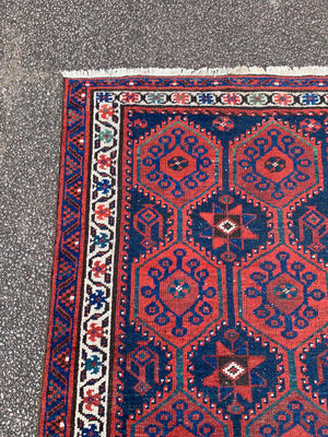 A long red ground blue Persian runner rug ~ 304cm x 104cm