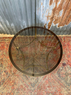 A rare circular brass and glass Hollywood Regency coffee table