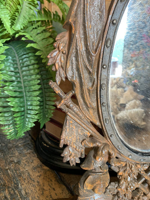 A cast iron table top mirror