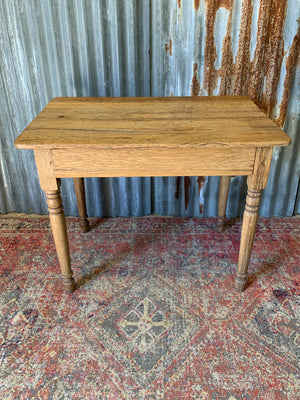 A Victorian oak table with single drawer