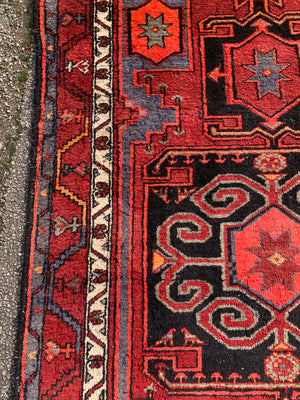 A Turkish red ground rug ~ 211cm x 138cm