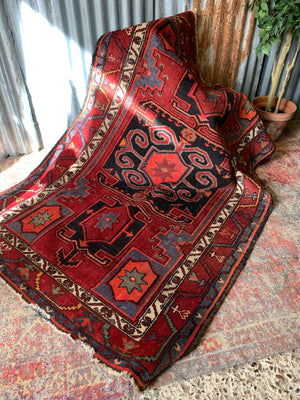 A Turkish red ground rug ~ 211cm x 138cm