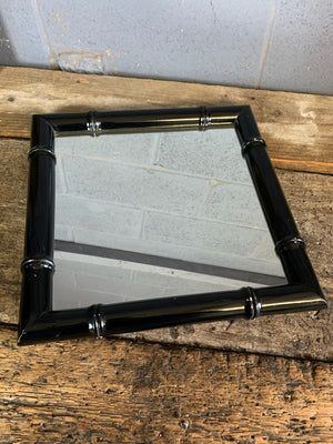 A square faux bamboo ebonised mirror