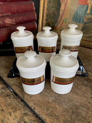 A set of five ceramic spice jars