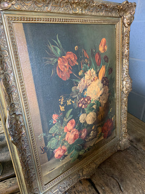 A framed floral oleograph