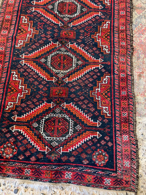 A Persian red & blue ground rectangular rug ~ 179cm x 96cm