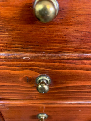 A miniature set of wooden two over three drawers