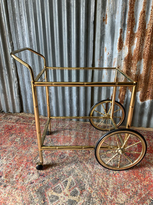 A faux bamboo Hollywood Regency two tier trolley