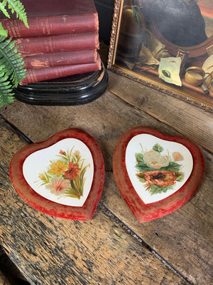 A pair of Victorian porcelain heart plaques on red velvet mounts