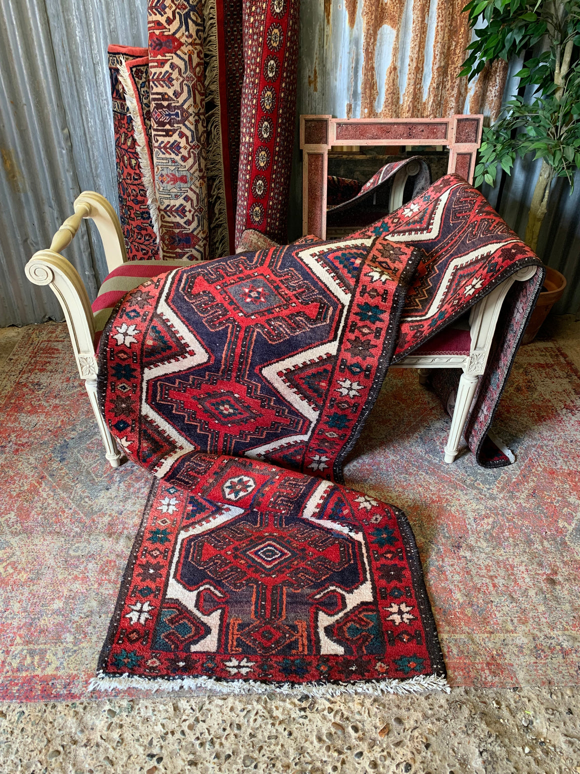 A red ground woolen Persian runner ~ 398cm x 76cm