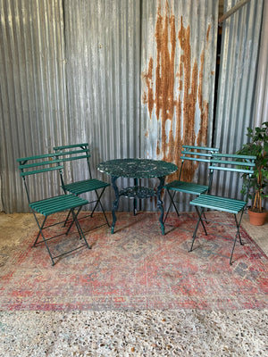 A green garden table and chairs set