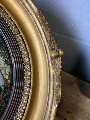 A large Regency style convex mirror with eagle surmount