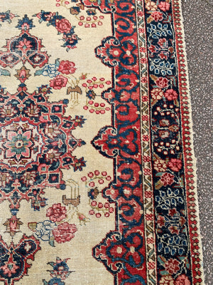 A Persian cream ground rug ~ 194cm x 133cm