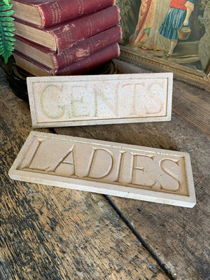 A pair of cast stone plaques ~ "LADIES" & "GENTS"