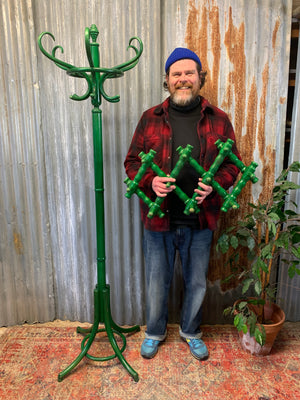 A tall bentwood coat stand with hat rack