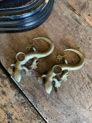 A pair of brass candlesticks in the form of lizards