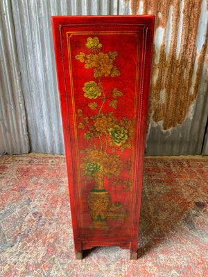 A red and gold lacquered chinoiserie cabinet