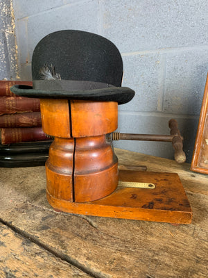 A wooden millinery hat stretcher