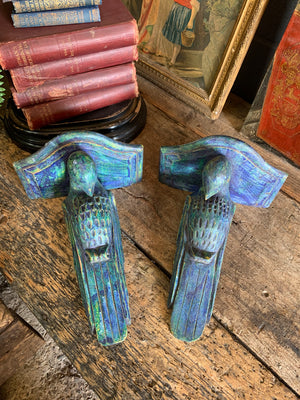 A pair of wooden corbels in the form of parrots