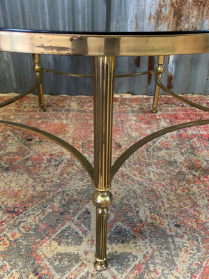 A rare circular brass and glass Hollywood Regency coffee table
