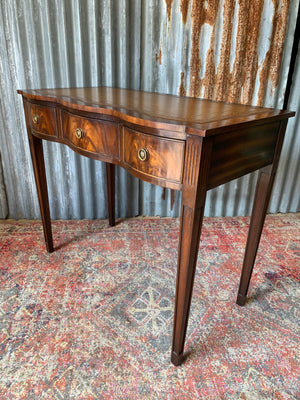 A serpentine desk and leather chair by Bevan Funnell