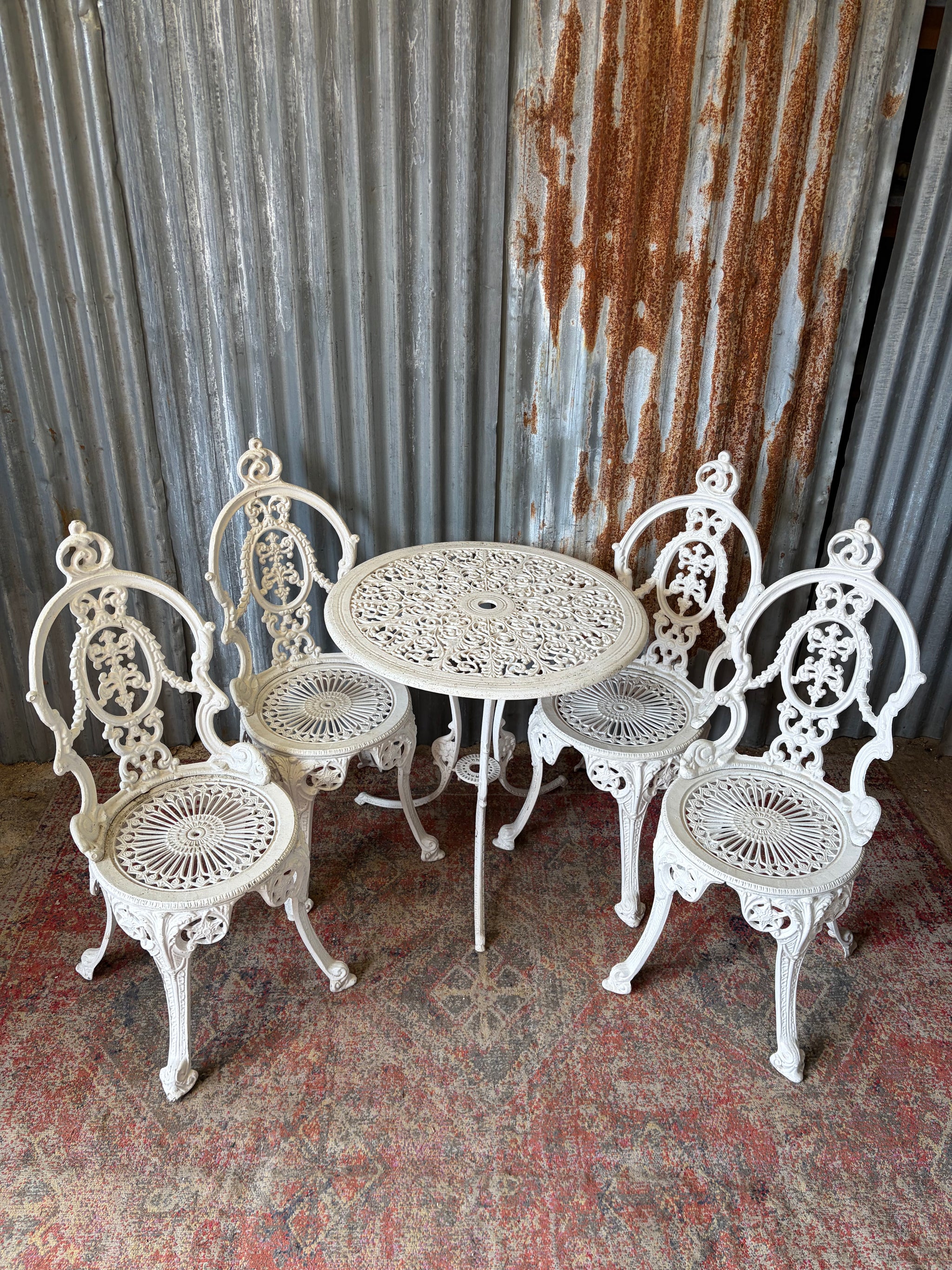 A white Regency style table and four chairs garden set