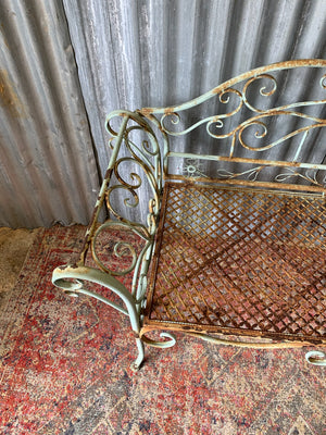 An ornate cast metal garden bench